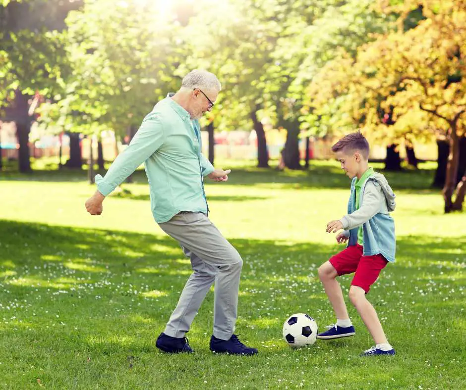 PLaying sport in the park kid with grandpa