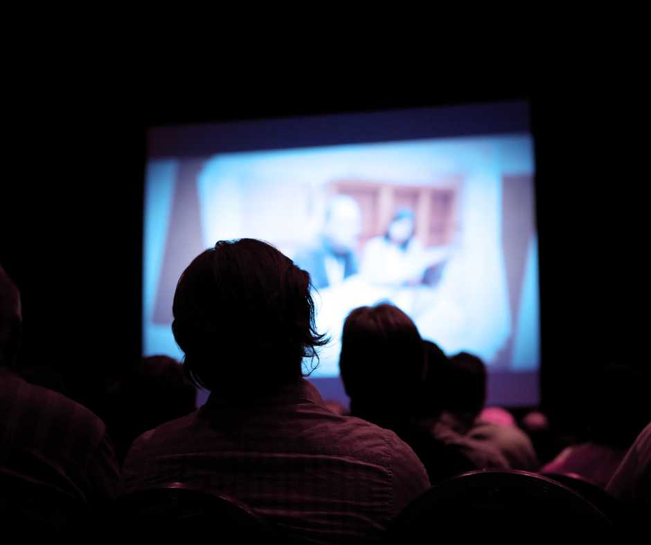 People watching a movie indoor cinema